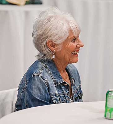 Woman sitting at table smiling