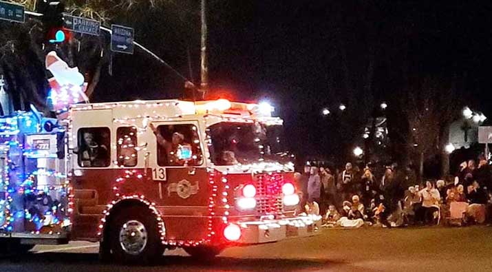 A fire truck in a holiday parade